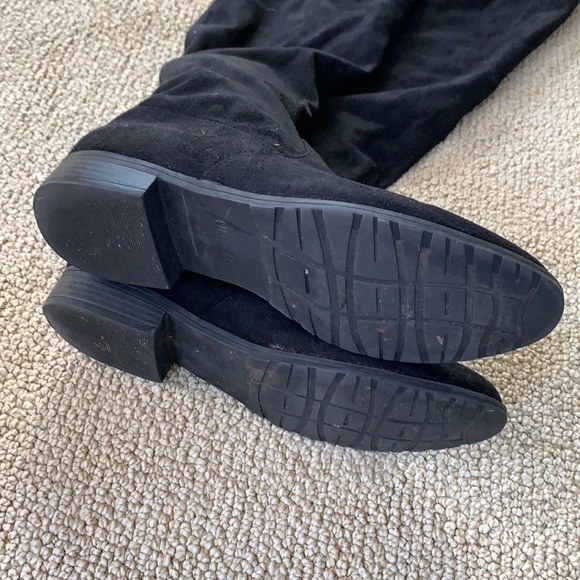 Tall black suede boots with ties to tighten at the calf. Size 8